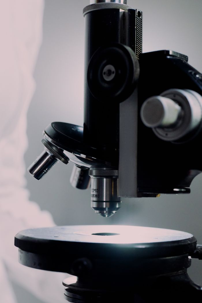 Detailed close-up of a microscope used in a laboratory environment for scientific research.
